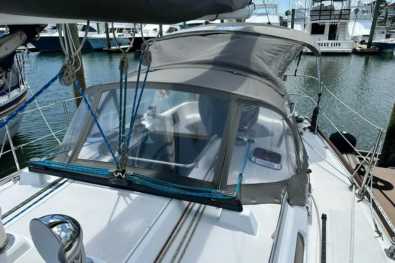 Slide: The Image of 2007 Sabre 386 sailboat docked, featuring a covered cockpit and rigging details. - 25