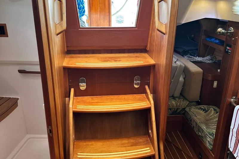 Slide: The Image of Wooden interior stairs of a 2007 Sabre 386 sailboat, leading to cabin area. - 47