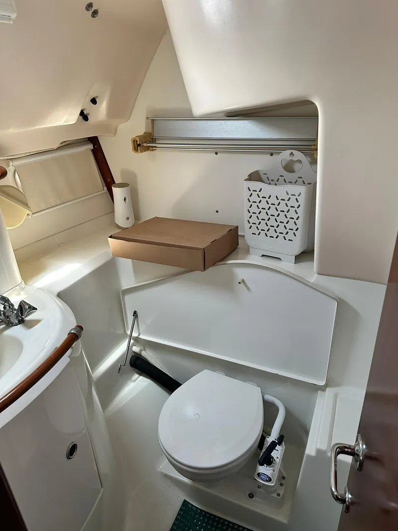 Slide: The Image of 1998 Beneteau 381 yacht bathroom with toilet, sink, and storage. - 26