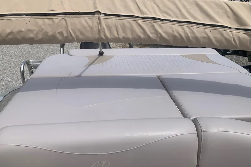 Slide: The Image of 2015 Avalon Windjammer Elite 25' boat with beige seating and canopy. - 13