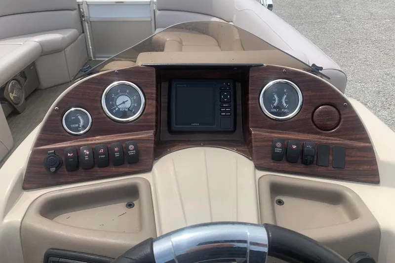Slide: The Image of Dashboard of 2015 Avalon Windjammer Elite 25' boat with gauges and controls. - 8