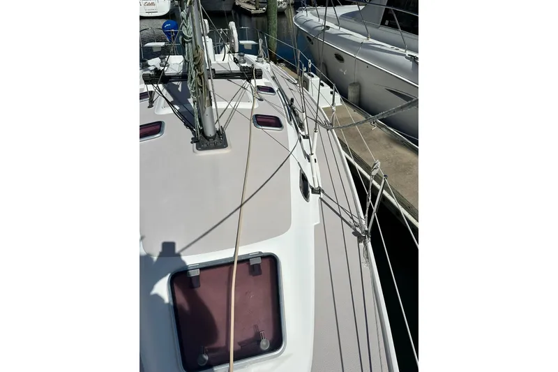 Slide: The Image of 2008 Catalina 320 sailboat deck with rigging and hatches in marina. - 10