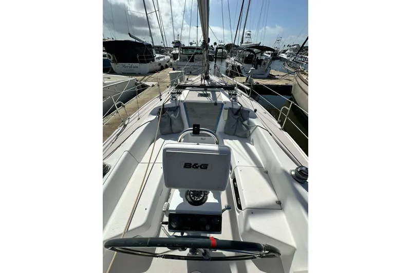 Slide: The Image of 2008 Catalina 320 sailboat cockpit view in marina, featuring B&G navigation system. - 30