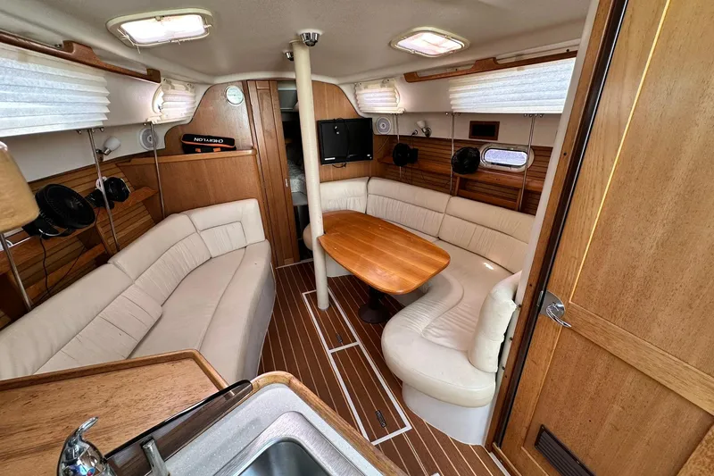 Slide: The Image of Interior of 2008 Catalina 320 sailboat with cozy seating and wooden table. - 49