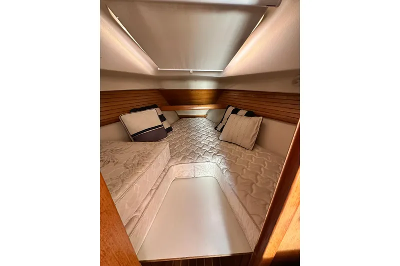 Slide: The Image of Cozy cabin interior of 2008 Catalina 320 sailboat with comfortable bedding and pillows. - 51
