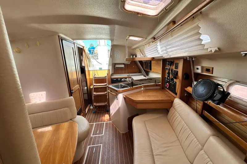 Slide: The Image of Interior of 2008 Catalina 320 sailboat with cozy seating and wooden finishes. - 54