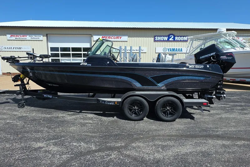 The Image of 2026 Yar-Craft 219TFX boat on trailer, parked outside dealership with Mercury engine. - 0