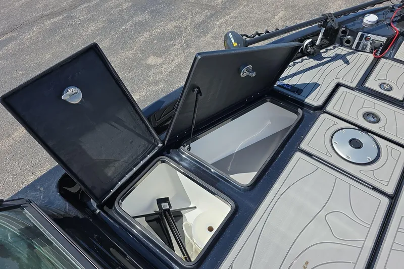 Slide: The Image of Open storage compartments on a 2026 Yar-Craft 219TFX boat deck. - 12