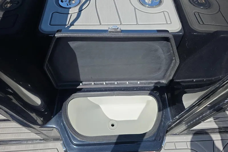 Slide: The Image of Open storage compartment on 2026 Yar-Craft 219TFX boat, showcasing interior design. - 24