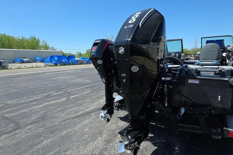 Slide: The Image of 2026 Yar-Craft 219TFX boat with powerful outboard motor in a parking lot. - 5