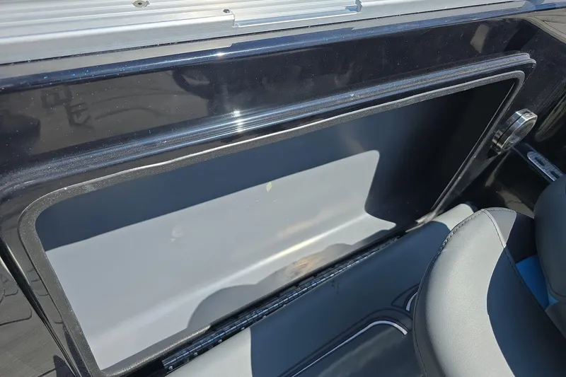 Slide: The Image of 2026 Yar-Craft 219TFX boat interior storage compartment with sleek design and comfortable seating. - 9