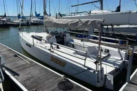 The Image of 2024 Beneteau First 27 sailboat docked at a marina, showcasing sleek design and modern features. - 0