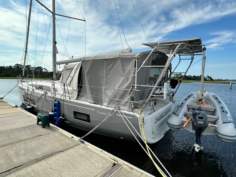 Slide: The Image of 2023 Beneteau Oceanis 46.1 yacht docked with inflatable boat, under a clear sky. - 18