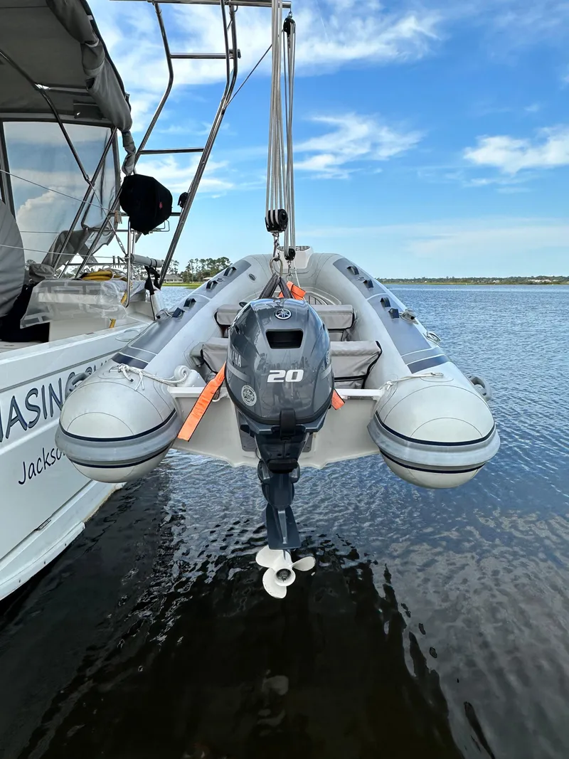Slide: The Image of Inflatable boat with outboard motor on Beneteau Oceanis 46.1, 2023 model, docked on water. - 19