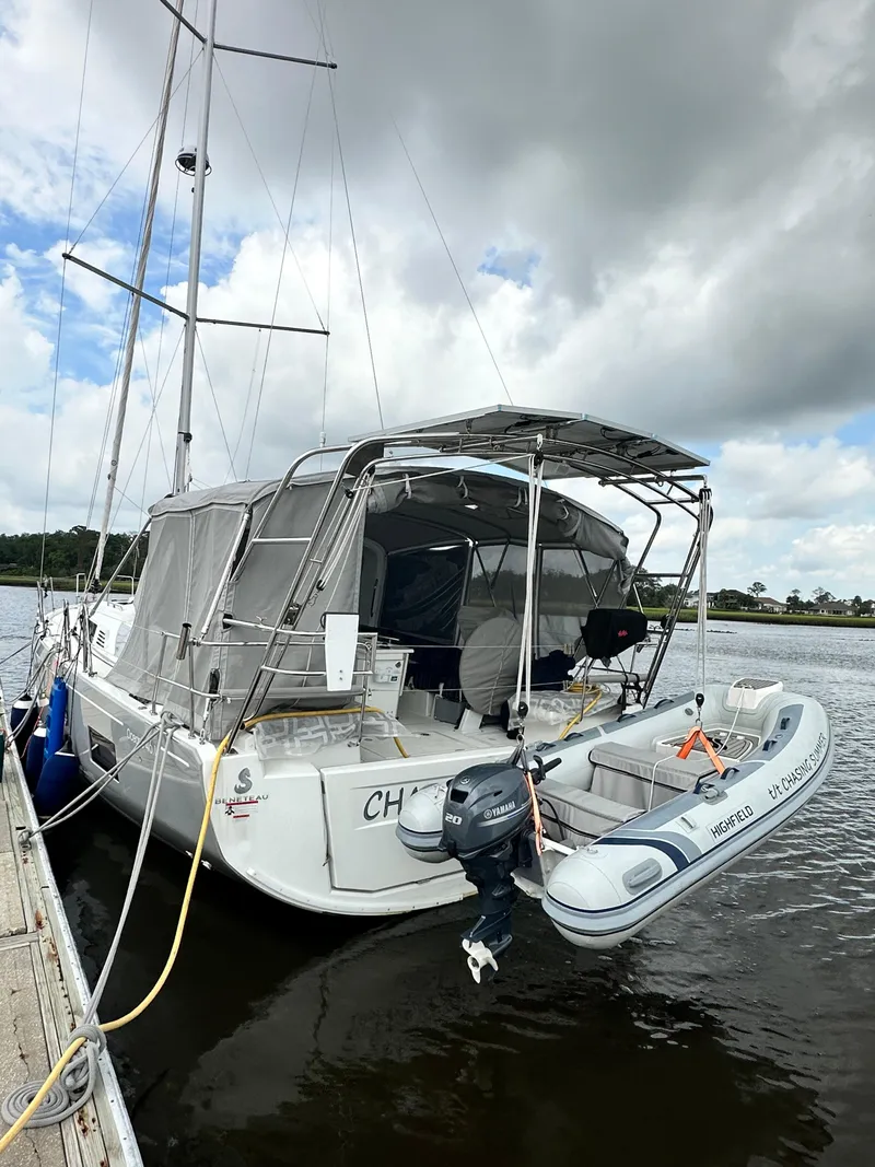 Slide: The Image of 2023 Beneteau Oceanis 46.1 sailboat docked with inflatable dinghy attached. - 2