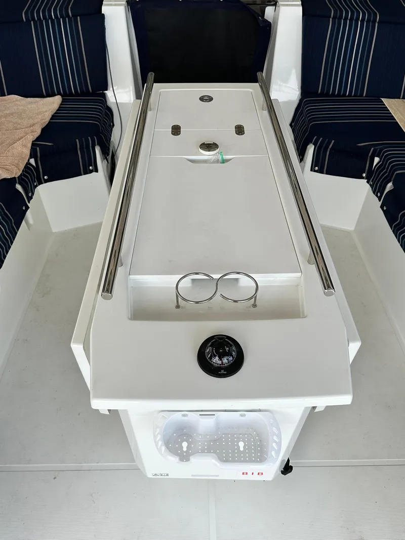 Slide: The Image of Cockpit of 2023 Beneteau Oceanis 46.1 with striped seating and central console. - 23