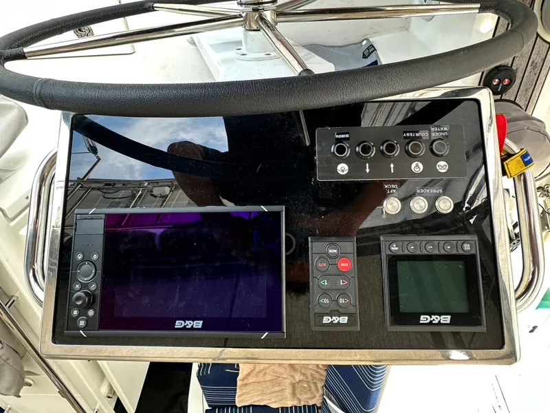 Slide: The Image of Steering console of 2023 Beneteau Oceanis 46.1 with navigation controls and displays. - 24