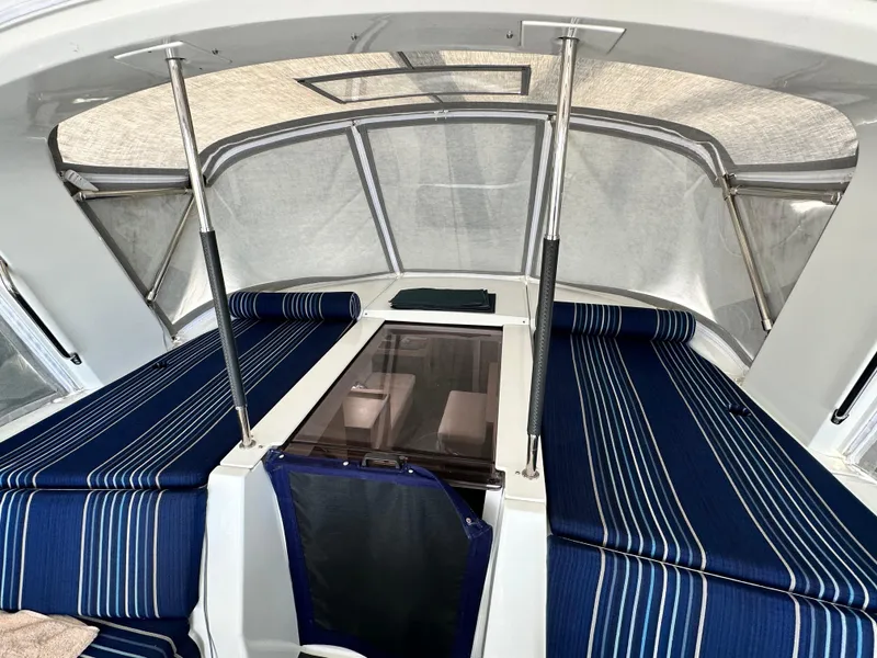 Slide: The Image of 2023 Beneteau Oceanis 46.1 cockpit with striped blue cushions and protective canopy. - 29