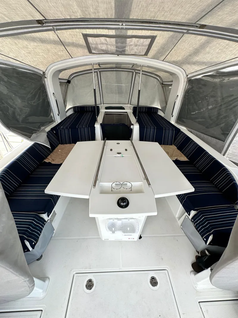 Slide: The Image of Interior of 2023 Beneteau Oceanis 46.1 yacht with striped seating and foldable table. - 31