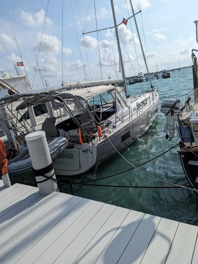 Slide: The Image of 2023 Beneteau Oceanis 46.1 yacht docked at marina, clear sky, calm waters. - 34