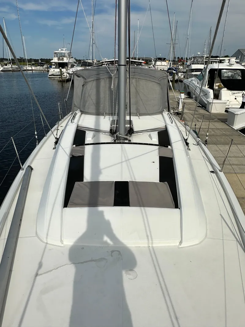 Slide: The Image of 2023 Beneteau Oceanis 46.1 sailboat docked at marina, view of deck and mast. - 8