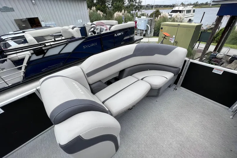 Slide: The Image of Sylvan L3 LZ 2022 pontoon boat with gray seating at dock. - 5