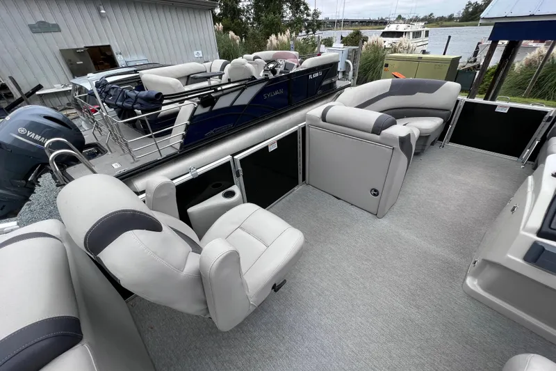 Slide: The Image of Interior of a 2022 Sylvan L3 LZ pontoon boat with gray seating. - 8