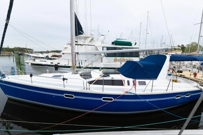 The Image of Sailboat docked at marina, 1996 Hunter 430 model, featuring a sleek blue hull. - 1