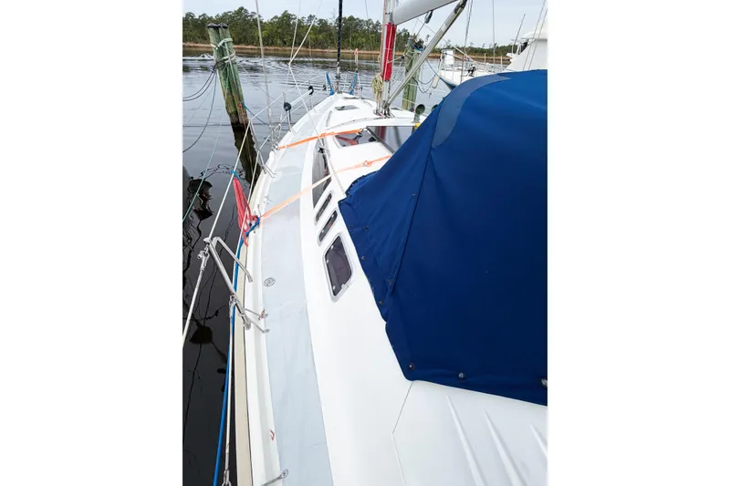Slide: The Image of Sailboat Hunter 430, 1996 model, docked with blue canopy and visible rigging. - 10