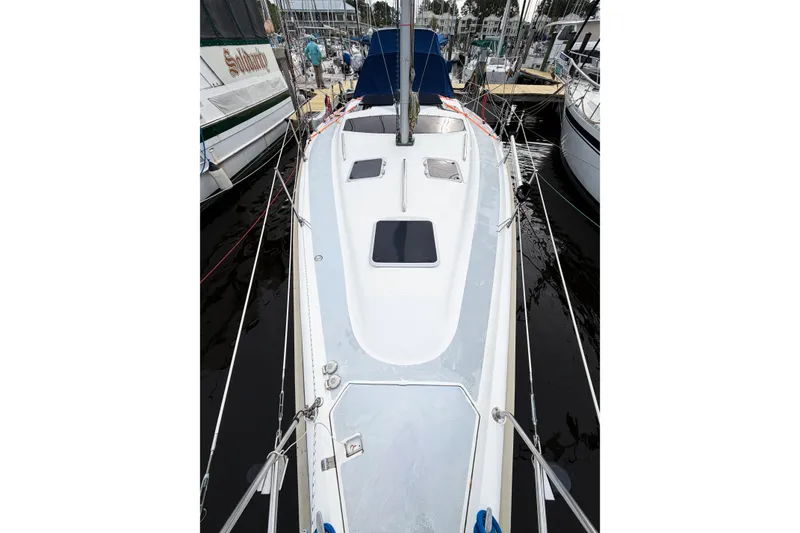 Slide: The Image of Hunter 430 sailboat from 1996 docked at a marina, showcasing its sleek deck design. - 12