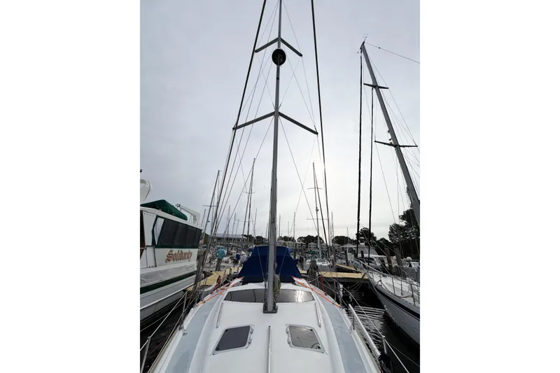 Slide: The Image of Sailboat Hunter 430, 1996 model, docked at marina with overcast sky. - 13