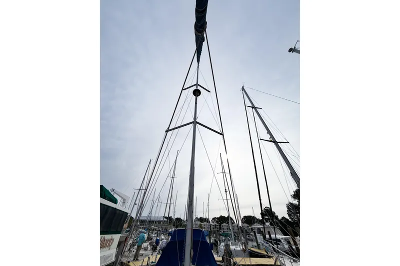 Slide: The Image of Sailboat mast view of 1996 Hunter 430 at marina, surrounded by other boats. - 14