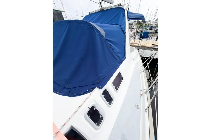 Slide: The Image of Sailboat Hunter 430, 1996 model, with blue cover docked at marina. - 18