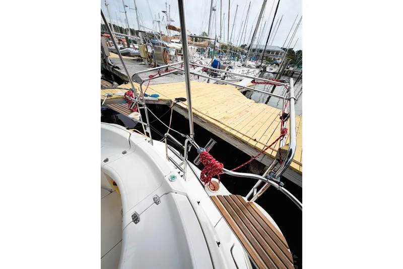 Slide: The Image of Hunter 430 sailboat from 1996 docked at a marina with wooden walkways. - 20