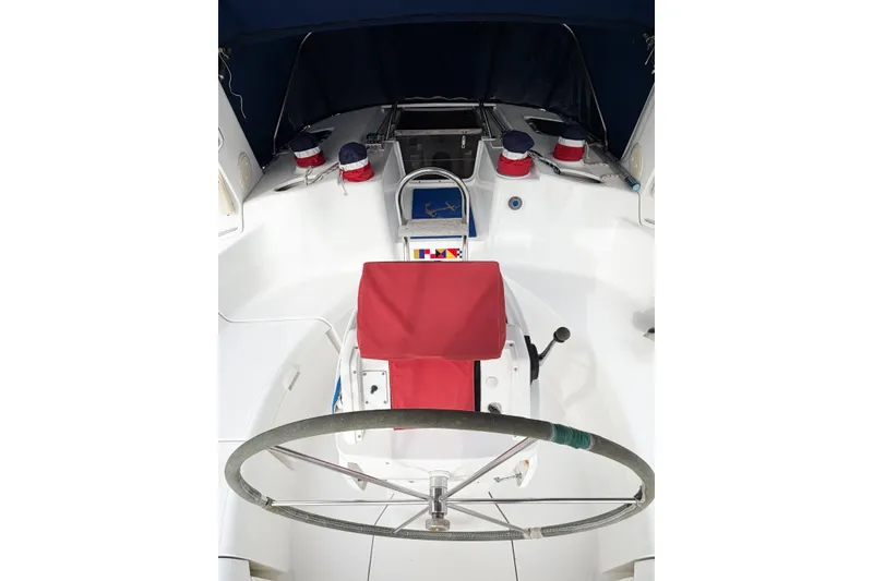 Slide: The Image of Cockpit of a 1996 Hunter 430 sailboat with red seating and steering wheel. - 21