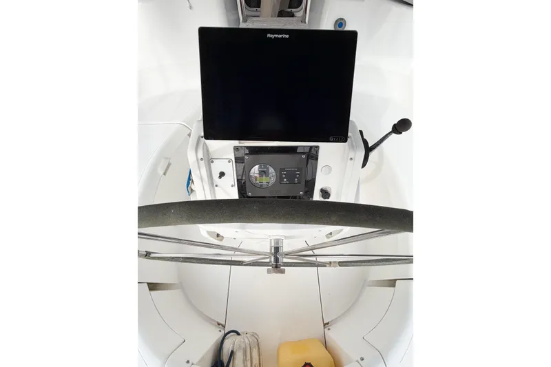 Slide: The Image of Cockpit of 1996 Hunter 430 sailboat with steering wheel and navigation equipment. - 22