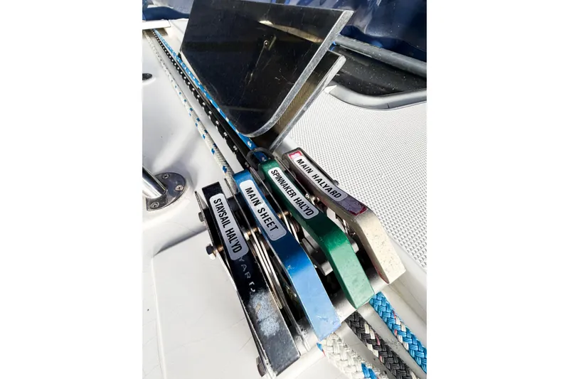 Slide: The Image of Sailing rigging on a 1996 Hunter 430 yacht, featuring labeled halyards and sheets. - 24
