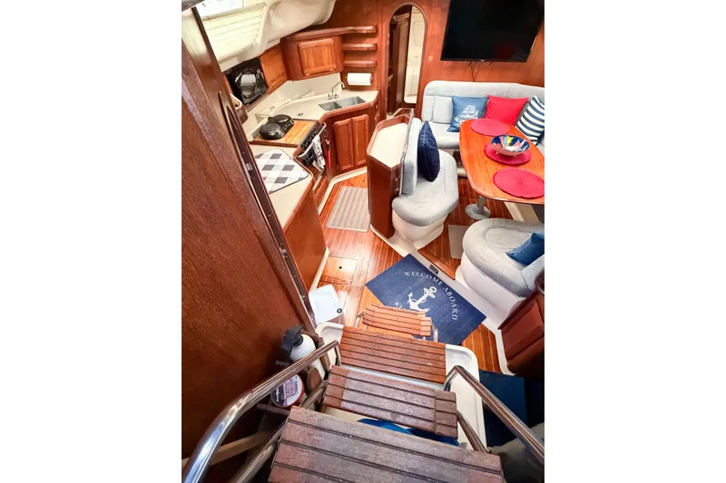 Slide: The Image of Interior of a 1996 Hunter 430 yacht with cozy seating and wooden finishes. - 26