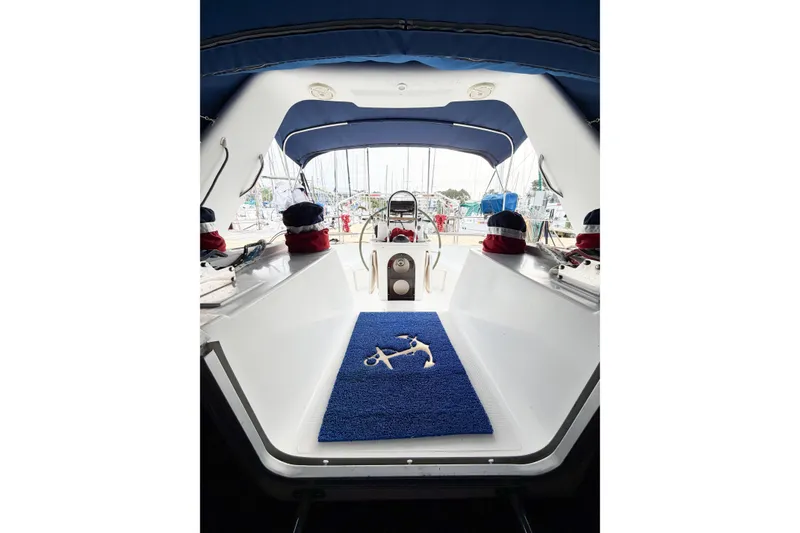 Slide: The Image of Interior view of a 1996 Hunter 430 sailboat cockpit with blue mat and nautical decor. - 27