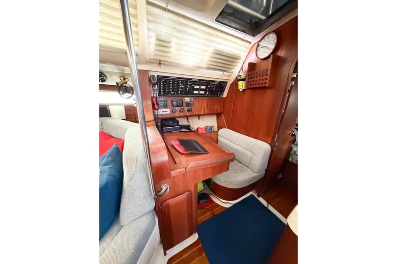 Slide: The Image of Interior of a 1996 Hunter 430 sailboat with navigation station and seating area. - 29