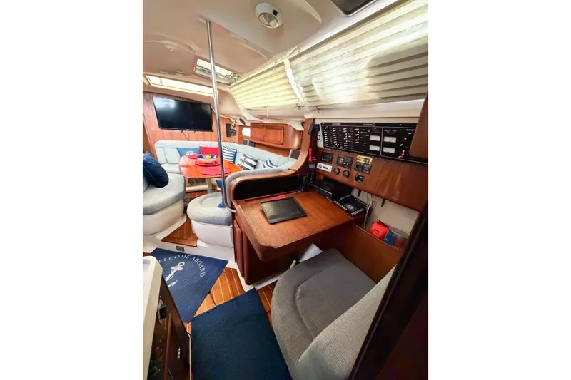 Slide: The Image of Interior of a 1996 Hunter 430 sailboat with navigation station and seating area. - 32