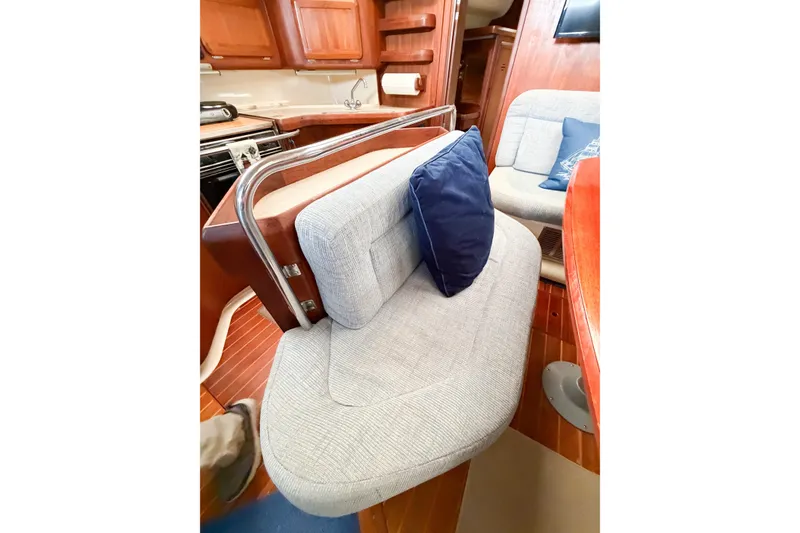 Slide: The Image of Interior of 1996 Hunter 430 yacht with cozy seating and wooden cabinetry. - 34