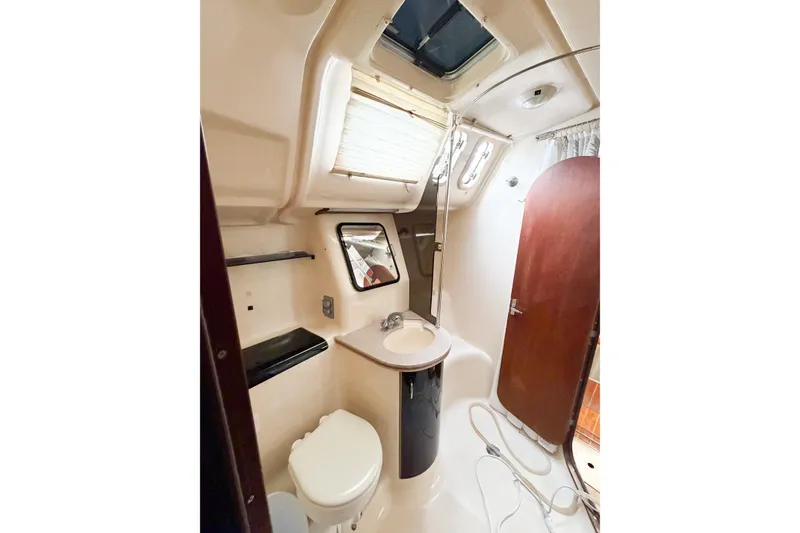Slide: The Image of Interior of 1996 Hunter 430 yacht bathroom with sink, toilet, and shower. - 40