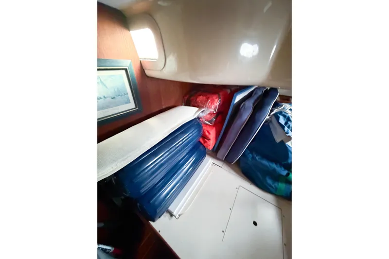 Slide: The Image of Interior of a 1996 Hunter 430 sailboat with cushions and framed artwork. - 42