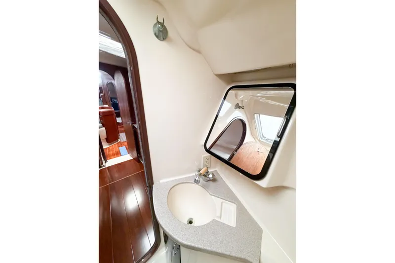 Slide: The Image of Interior of 1996 Hunter 430 yacht bathroom with sink, mirror, and wooden flooring. - 45