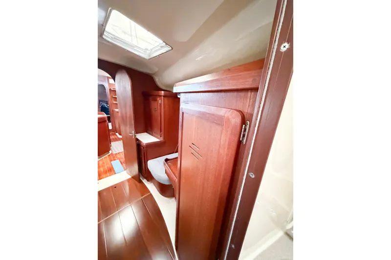 Slide: The Image of Interior of 1996 Hunter 430 sailboat with wooden cabinetry and seating area. - 49