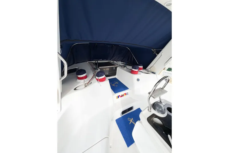 Slide: The Image of Interior view of a 1996 Hunter 430 sailboat cockpit with blue canopy and nautical decor. - 5