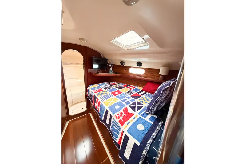 Slide: The Image of Cozy cabin interior of 1996 Hunter 430 sailboat with colorful bedding and wooden accents. - 51