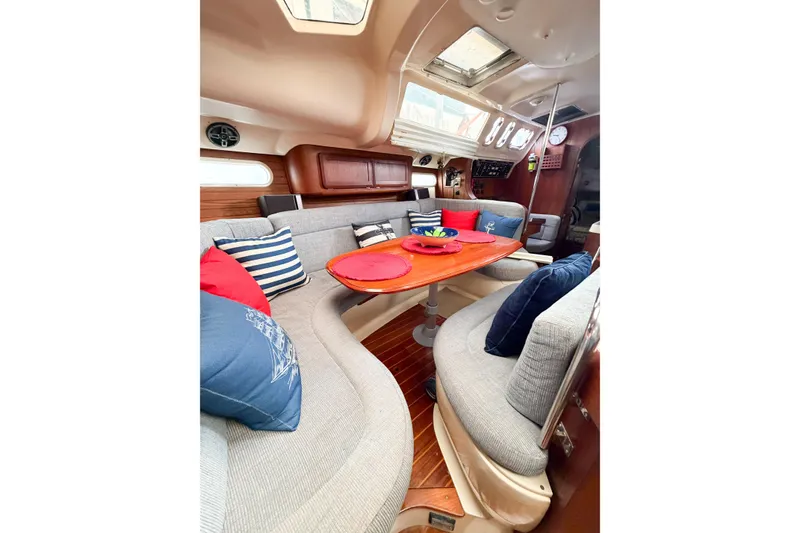 Slide: The Image of Interior of a 1996 Hunter 430 sailboat with cozy seating and nautical decor. - 53