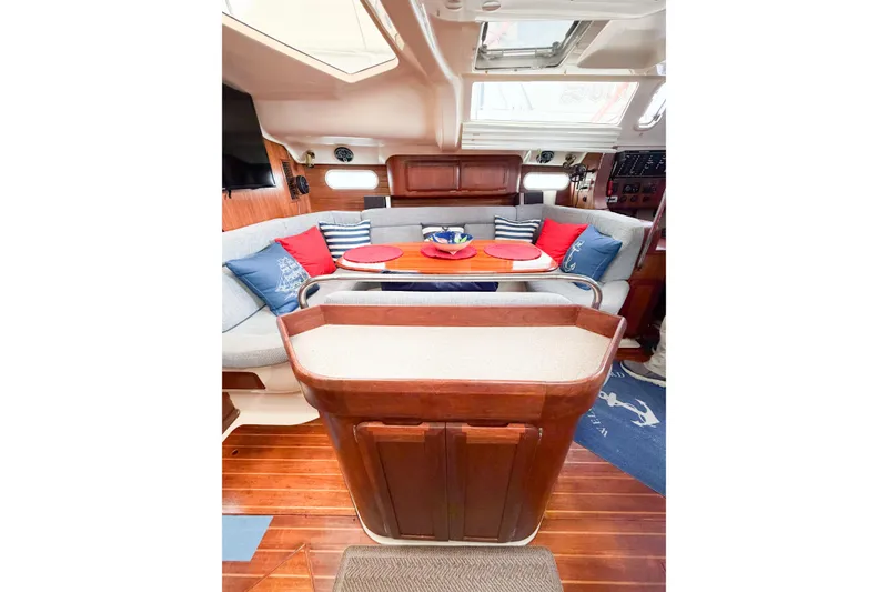 Slide: The Image of Interior of a 1996 Hunter 430 sailboat with cozy seating and nautical decor. - 55
